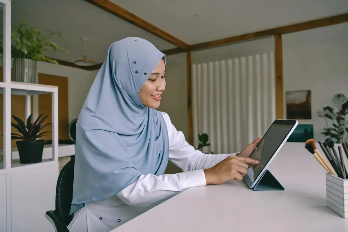 A beauty salon owner checking appointments on a tablet