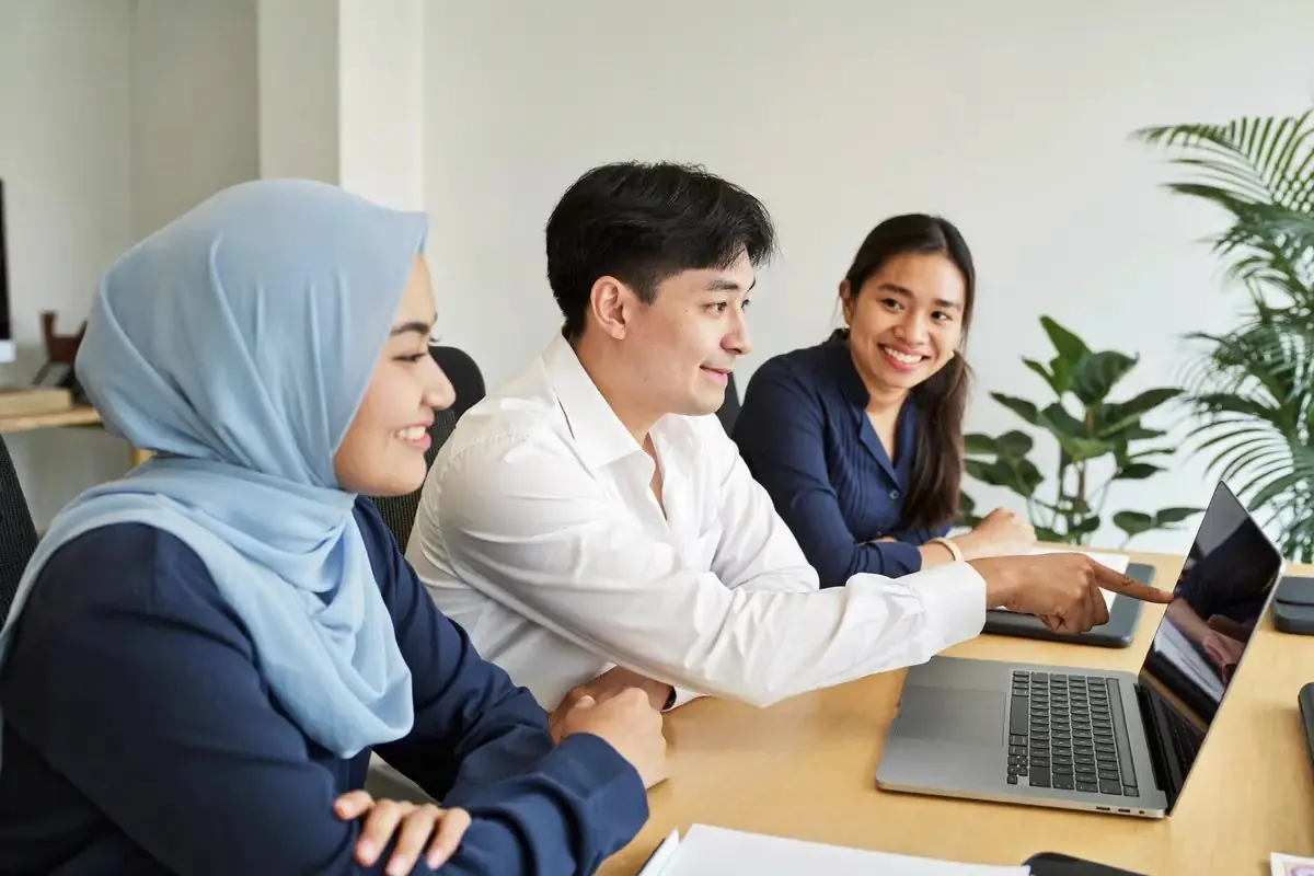A small team reviewing results together on a laptop
